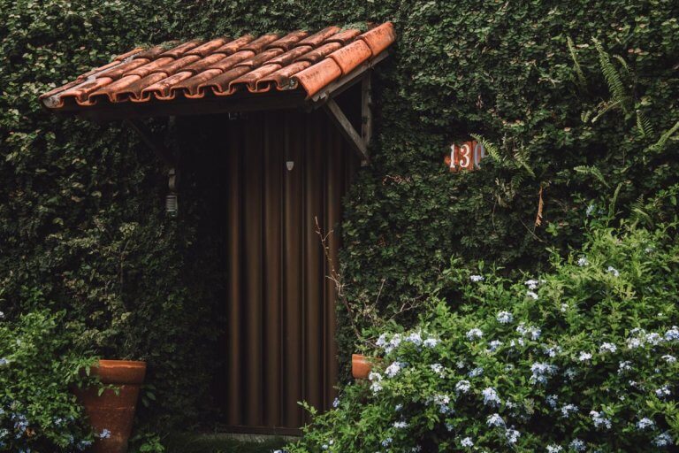 Entrée d'une maison aux tuiles terracotta entourée de verdure, lieu serein dans le Gard près de Nîmes